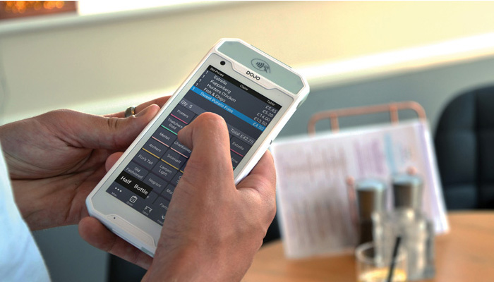 Waitress holding tablet serving customers
